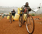 Ffood, water and energy for everyone are key issues that need to be addressed at the Durban COP17 climate talks. In this image from Nairobi, Kenya, a man uses his bicycle to bring home plastic water containers, previously filled at a water depot.